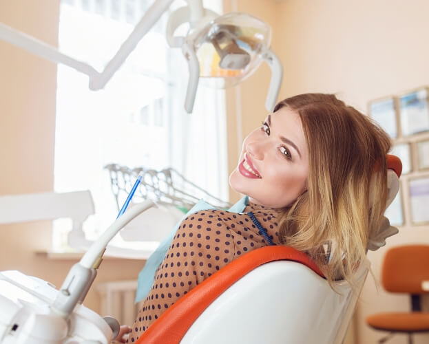 Woman in modern dental treatment room with advanced dentistry technology