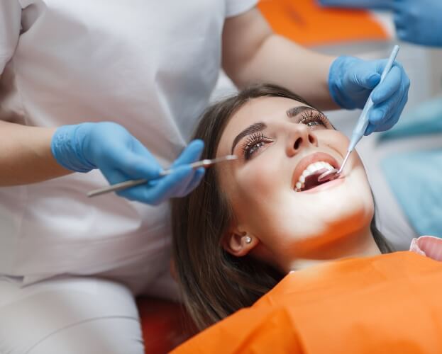 Woman receiving thorough dental evaluation