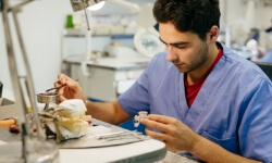 Dental lab technician crafting dental restoration