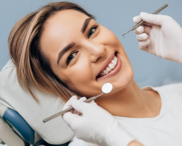Woman smiling during preventive dentistry checkup and teeth cleanings