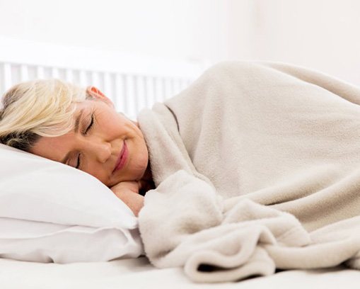 Woman sleeping peacefully in her bed