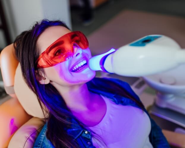 Woman receiving teeth whitening