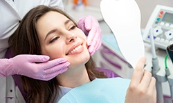 woman smiling while visiting cosmetic dentist