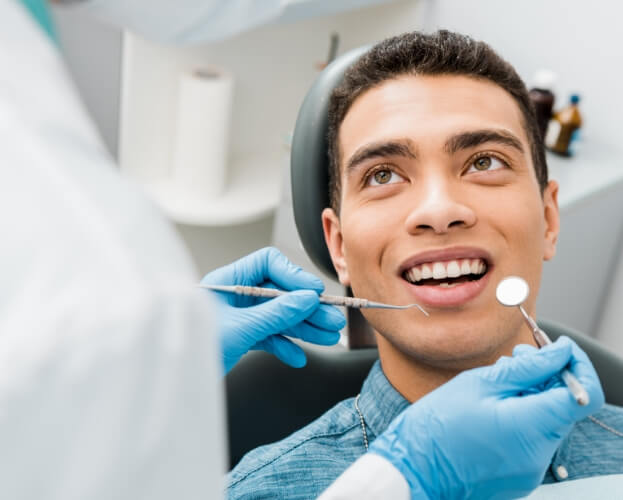 Man receiving dental checkup and teeth cleaning