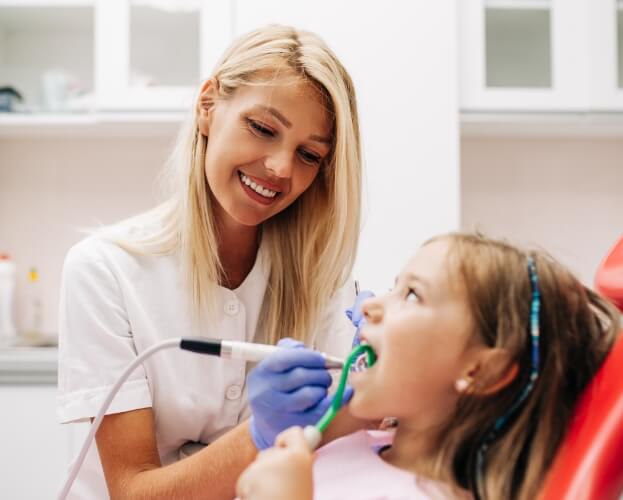 Child receiving refreshing dental hygiene treatment