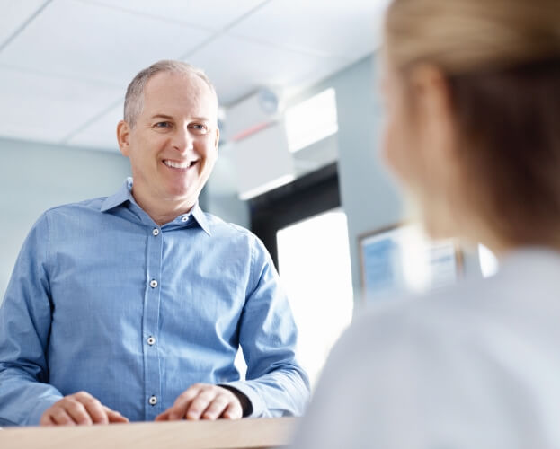 Man discussing the cost of dental implants