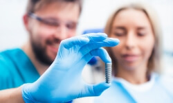 Dentist and patient discussing the stages of dental implant treatment