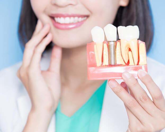 Dentist answering dental implant frequently asked questions