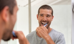 Man maintaining his oral hygiene routine