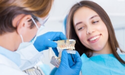 Woman discussing ways to protect dental implants