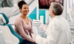 Woman talking to dentist during regular dental checkup