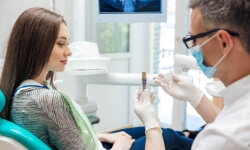 Woman talking to dentist during initial dental implant consultation
