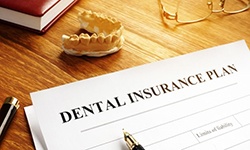 Dental insurance plan document on desk