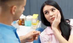 Woman talking to dentist during emergency dentistry consultation