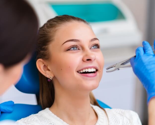 Woman receiving tooth extraction