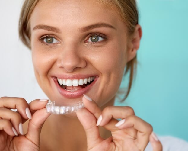 Dental patient using a take home teeth whitening kit