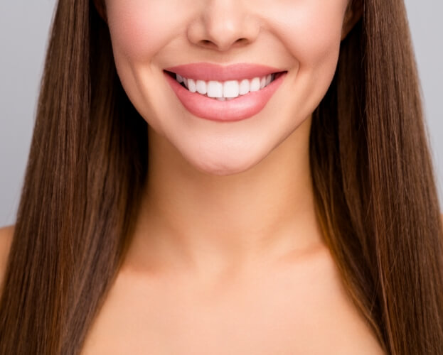 Smiling woman enjoying the benefits of porcelain veneers