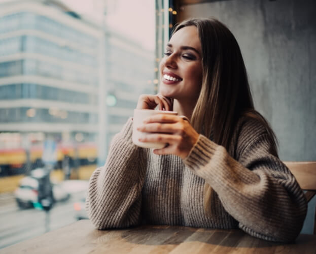 Woman with flawless smile after porcelain veneers