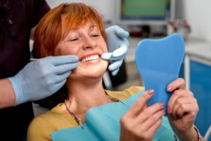 Older woman smiling in dentist’s chair