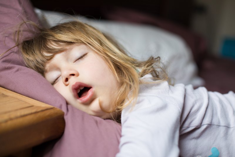 Young girl snoring and sleeping on her stomach