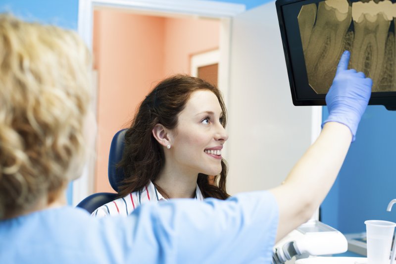 A dentist teaching a patient about dental implants in Casper.