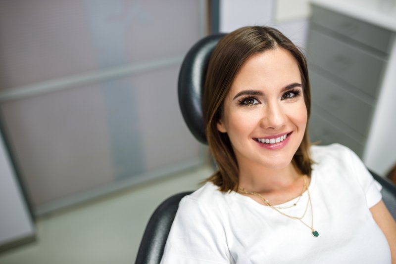 person with dental sealants smiling at dentist