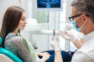 Woman learning the qualities of a good dental implant candidate